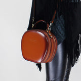 tan round leather handbag