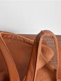 Close-up of a tan leather handbag 