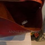 Close-up of the interior of a dark red or burgundy handbag