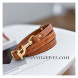A brown leather belt with gold-tone hardware