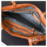 close-up of A brown woven leather shoulder bag 