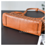 close-up of tan woven leather tote bag
cognac woven leather tote bag