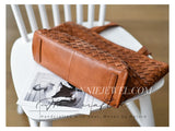 A brown woven leather shoulder bag 