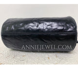 A black leather cylindrical bag
