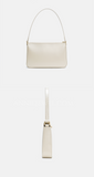 An off-white leather shoulder bag shown from the front and side