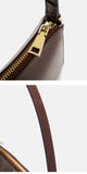 Close-up detail shots of a dark brown leather handbag, showing a gold-tone zipper pull and a brown shoulder strap
