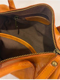 Close-up of the interior of a tan leather handbag