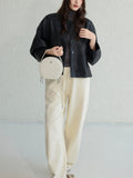 white leather round bag with zipper
leather circle bag with top handle womens