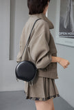 small black leather round bag with zipper
leather circle bag with top handle womens