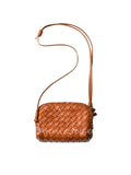 A small woven leather shoulder bag in a warm tan-brown color