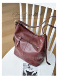 A brown leather shoulder bag with gold-tone hardware